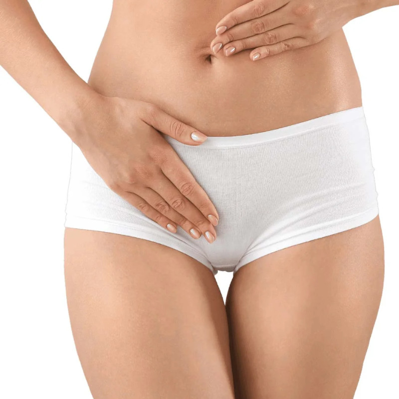 Woman holding lower abdomen representing intimate wellness and vaginal rejuvenation treatment in Birmingham