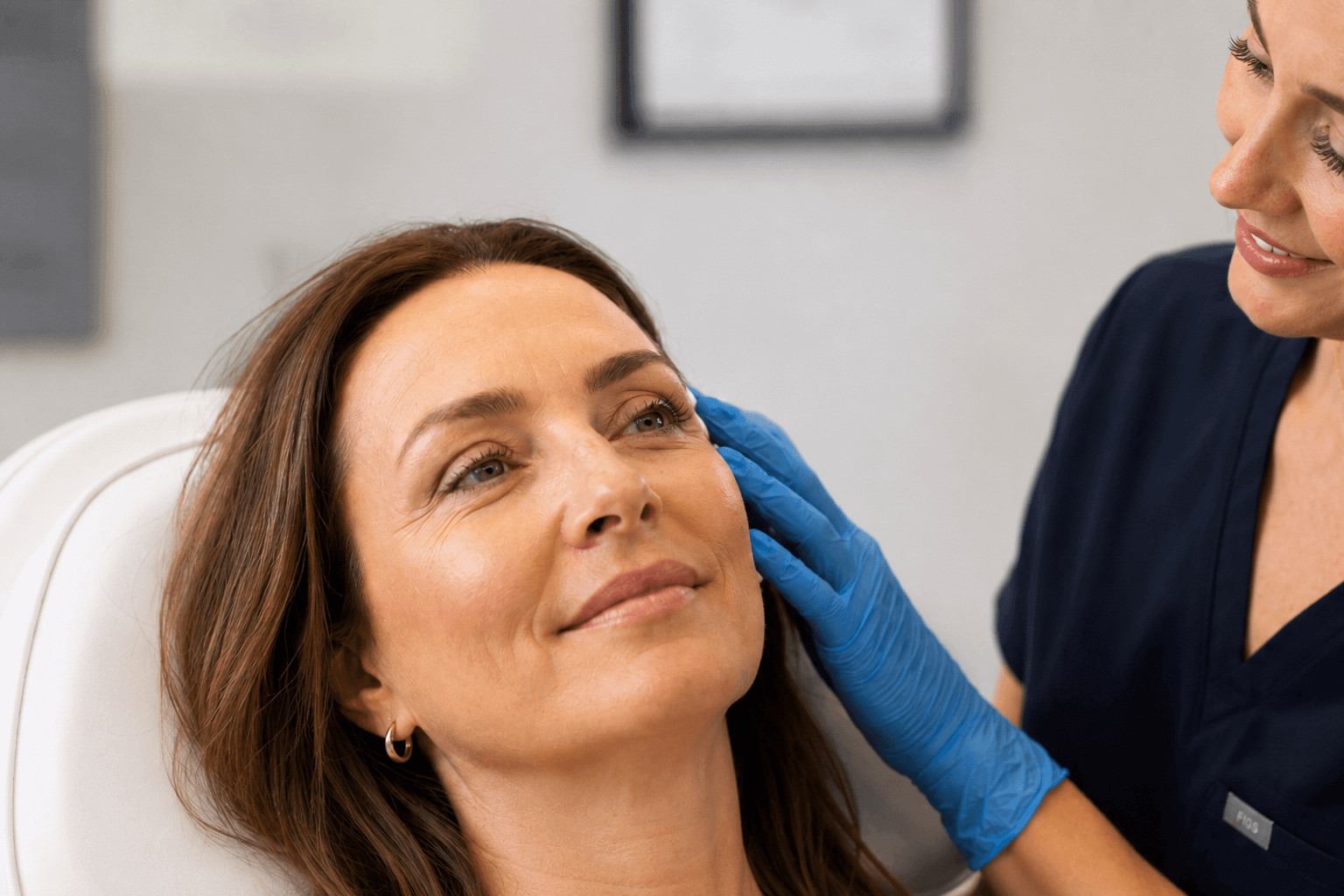 Aesthetic practitioner assessing a client's skin before Botox treatment at Dermoperfection clinic, Birmingham